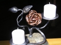 dual candles in rock with rose