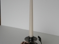 tall candlestick in rock with rose