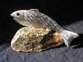 stainless steel fish on rock
